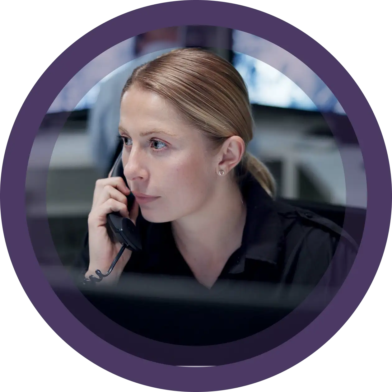 Security woman on the phone with screens behind