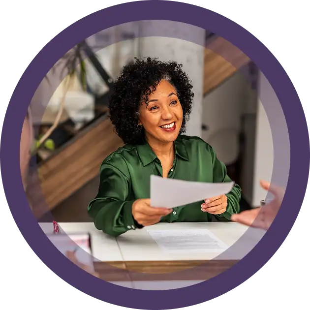 Woman smiling with a document in her hand
